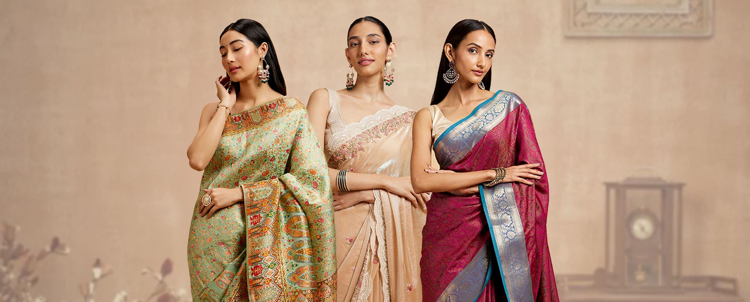 Three models in handloom sarees — mint, cream, and magenta — full-length portrait on a soft beige backdrop